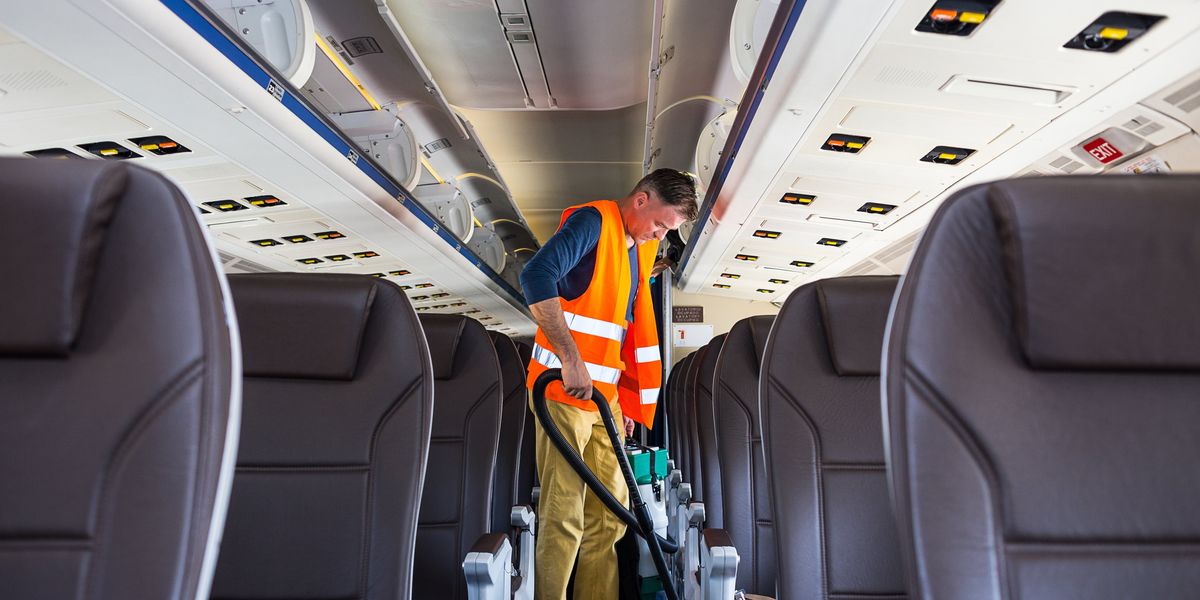 egy takarító takarítja a repülőt