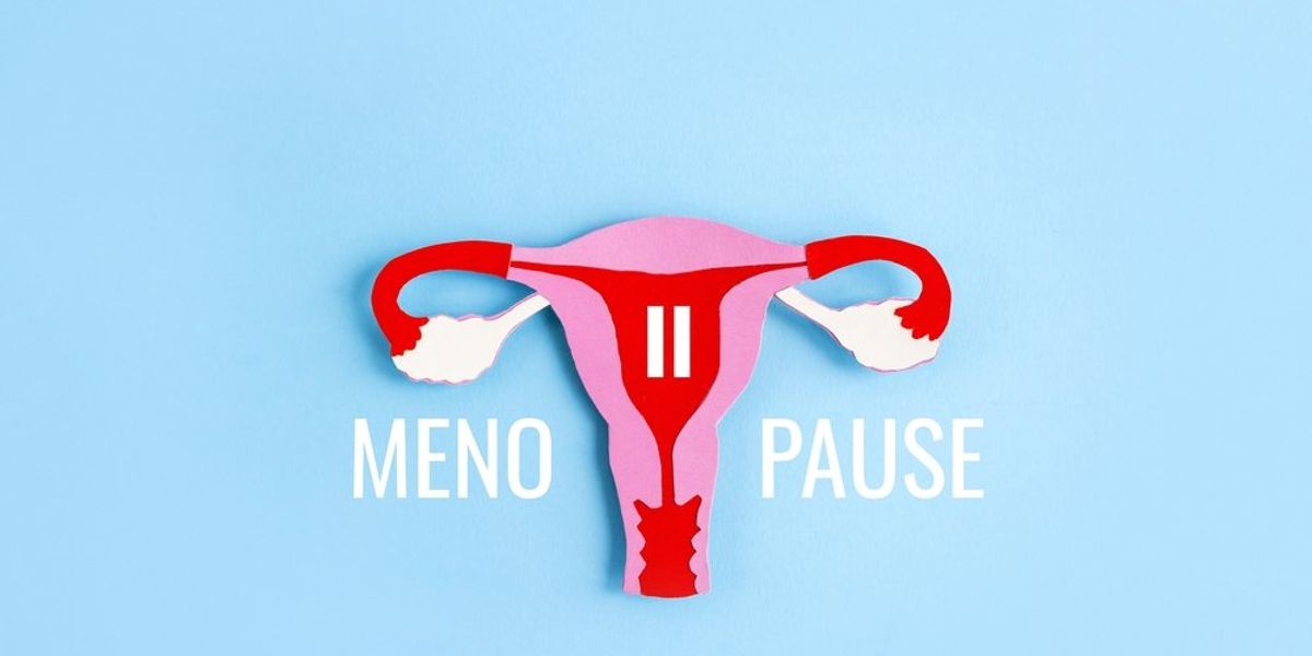 Női méh alakú papírforma és a menopauza szó kék háttéren