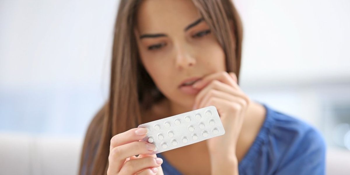 egy nő nézi a tablettákat