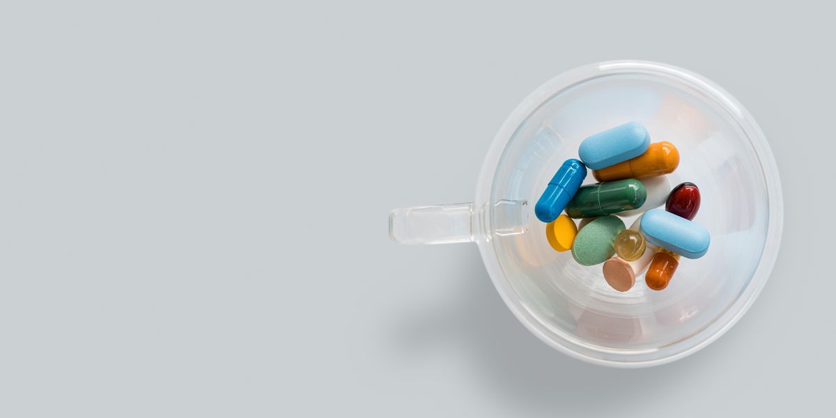 green and white medication pill in clear glass jar