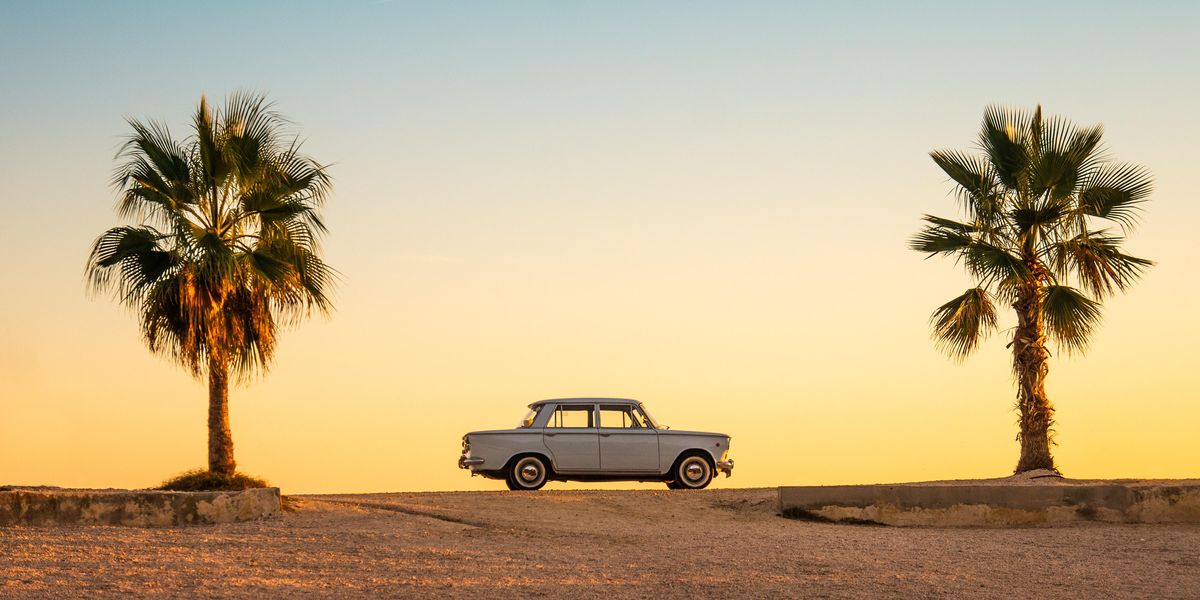 white and black car on brown sand during daytime