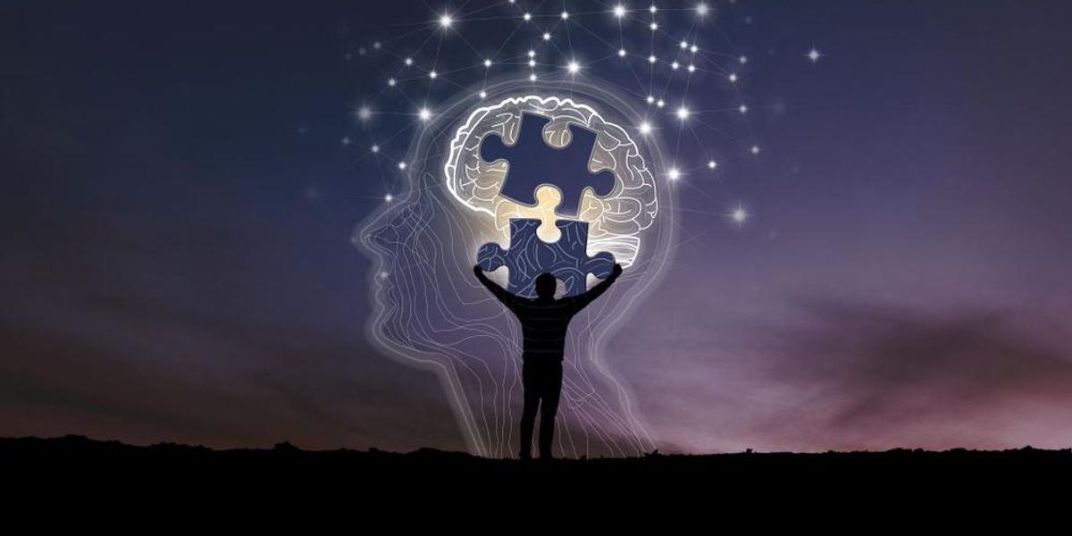 Agy és benne lévő puzzle képet tartó ember