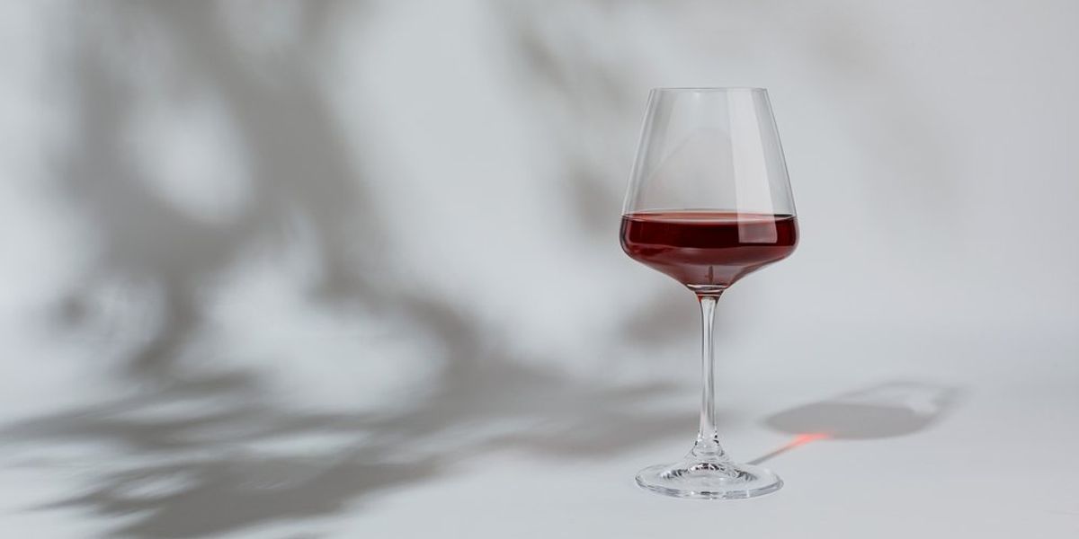 Vörösbor egy pohárban fehér háttéren