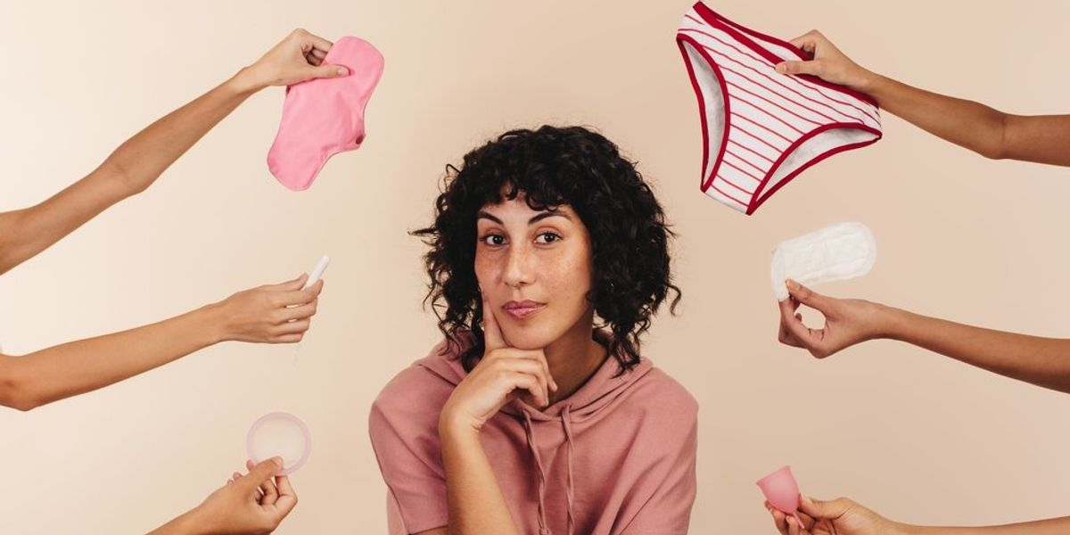 Nő, körülötte különböző menstruációs és egészségügyi termékeket nyújtó kezek 