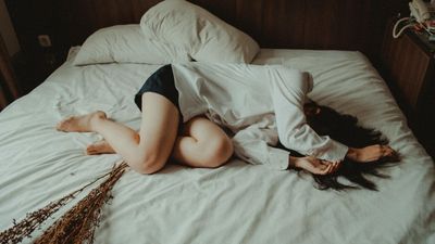 Egy lány szomorúan fekszik az ágyon