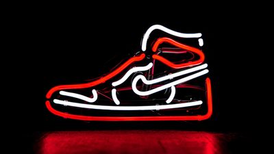 red and white Nike basketball shoe neon signage